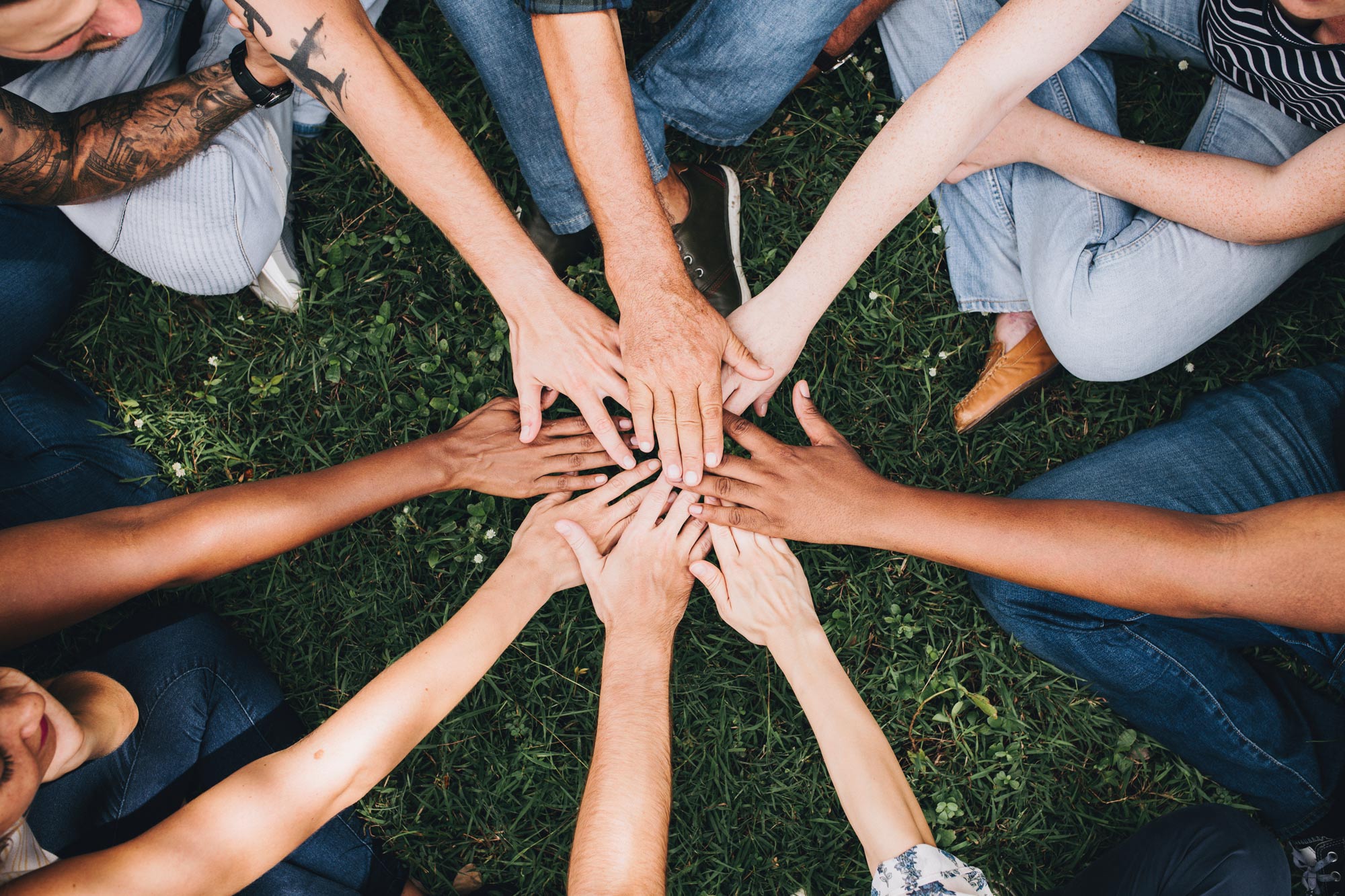 Diverse Christian community joining hands in prayer and fellowship